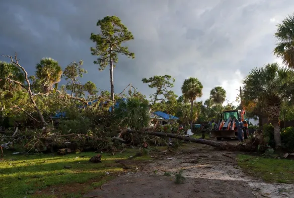 Emergency storm debris clearing on residential property in Jacksonville Beach, FL, after hurricane damage