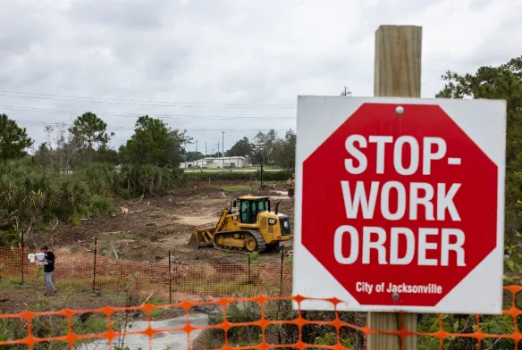 land clearing permit jacksonville fl stop work order cat bulldozer halted north jacksonville commercial site duval county